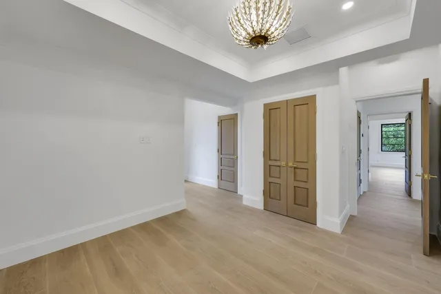 a view of a white house with a yard and plants