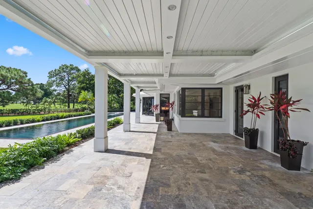 a aerial view of a house with yard swimming pool and outdoor seating