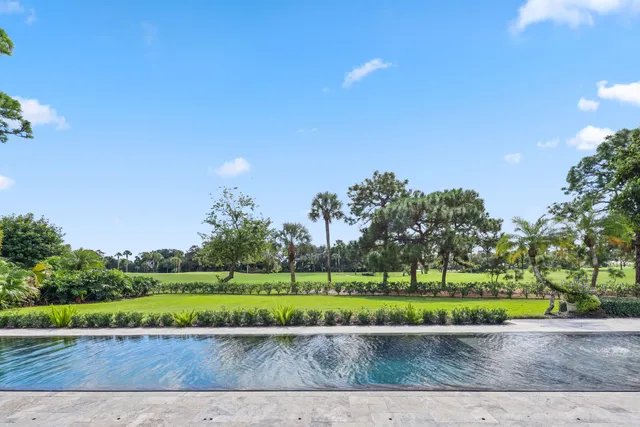 front view of a house with a yard and street