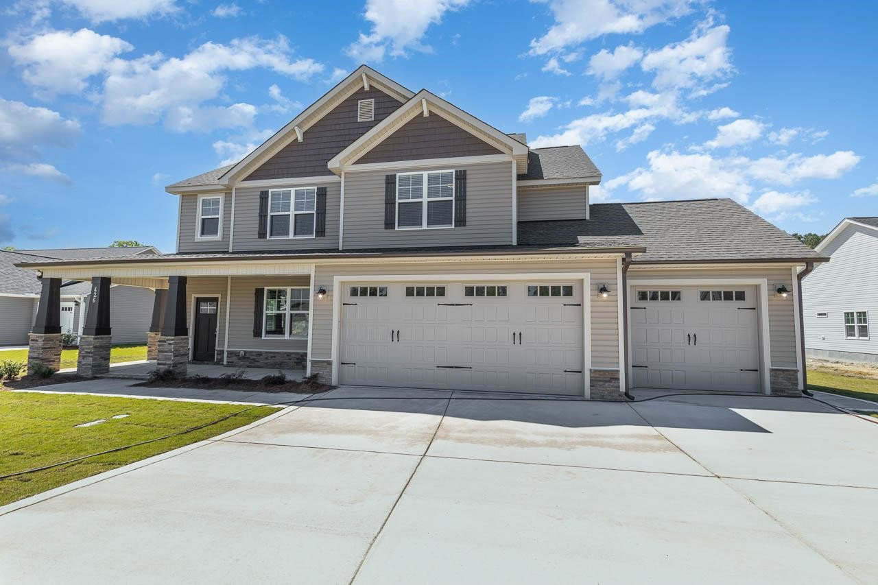 426 Jackson Pond Drive Smithfield, NC 27577 - Photo 2 of 32 a view of a white house with a swimming pool and lawn chairs under an umbrella