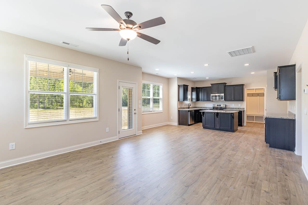 426 Jackson Pond Drive Smithfield, NC 27577 - Photo 5 of 32 a view of kitchen with microwave a stove and wooden floors