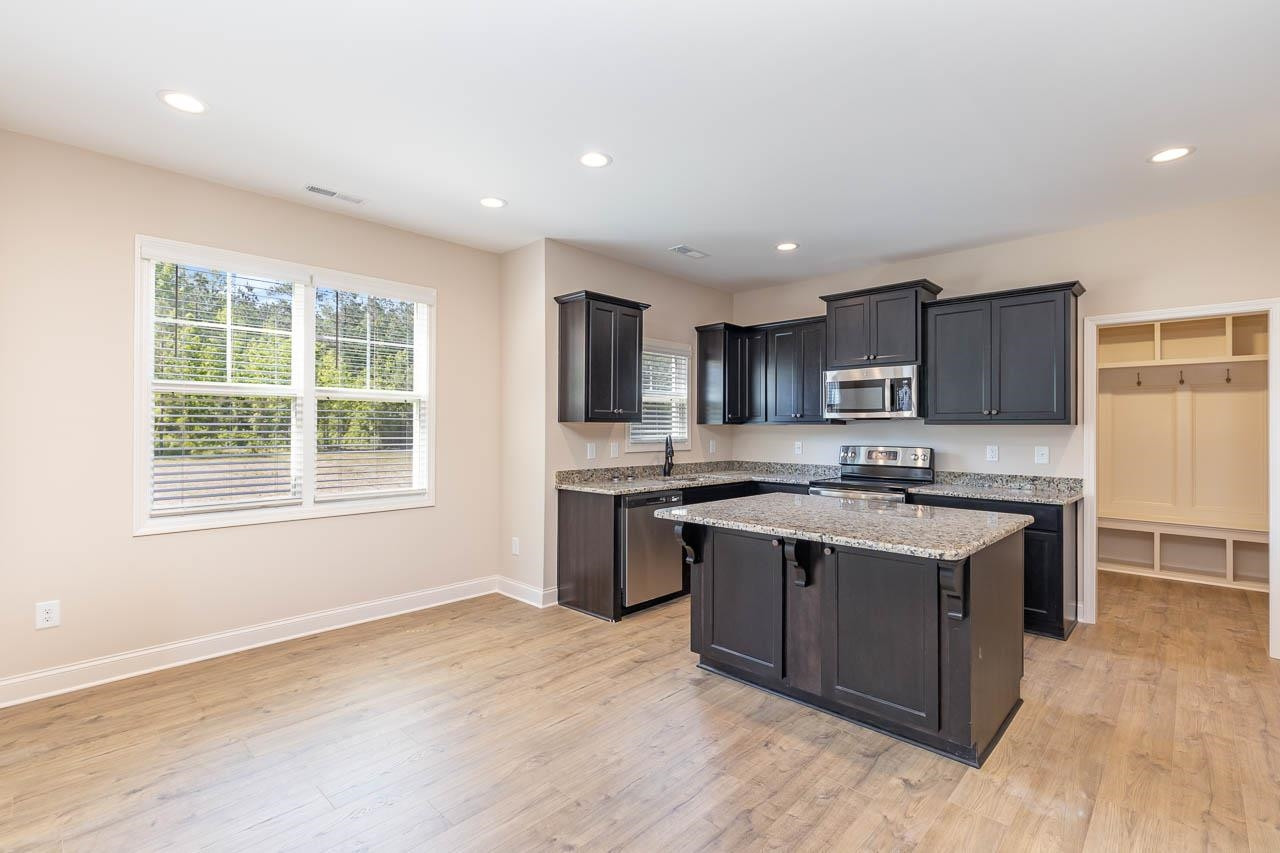 426 Jackson Pond Drive Smithfield, NC 27577 - Photo 9 of 32 a kitchen with stainless steel appliances granite countertop a stove and a sink