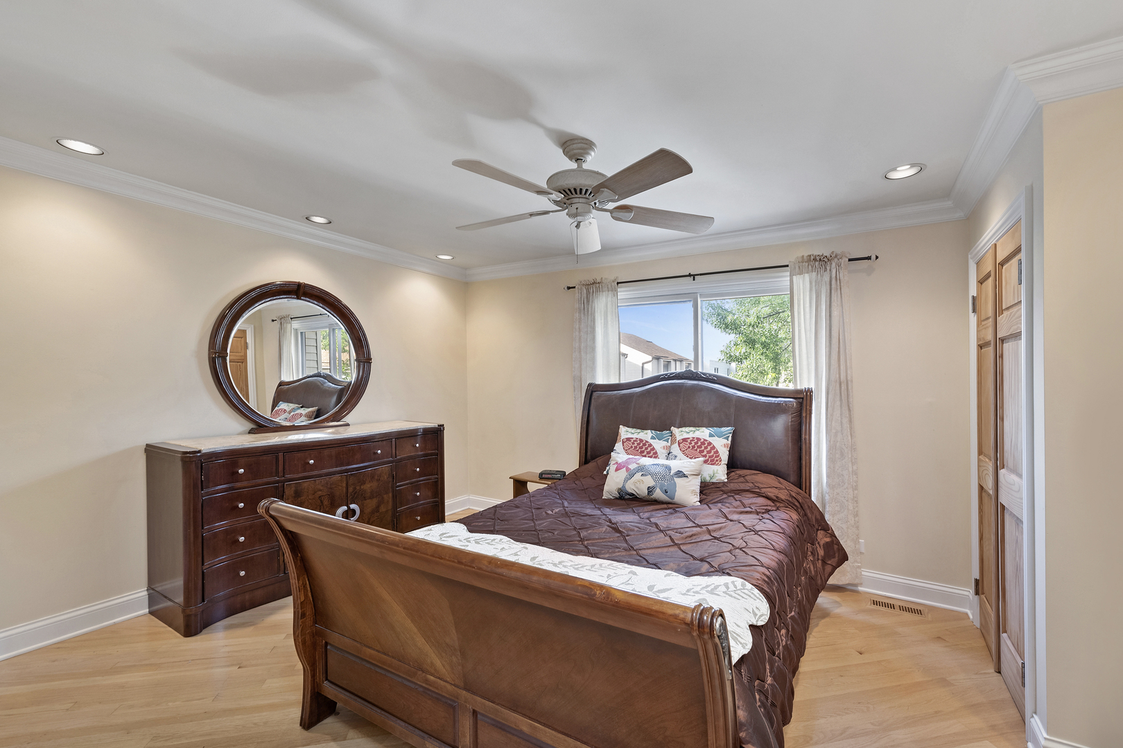 375 Juniper Tree Court Hoffman Estates, IL 60169 - Photo 12 of 24 a bed room with a bed a dresser and a window