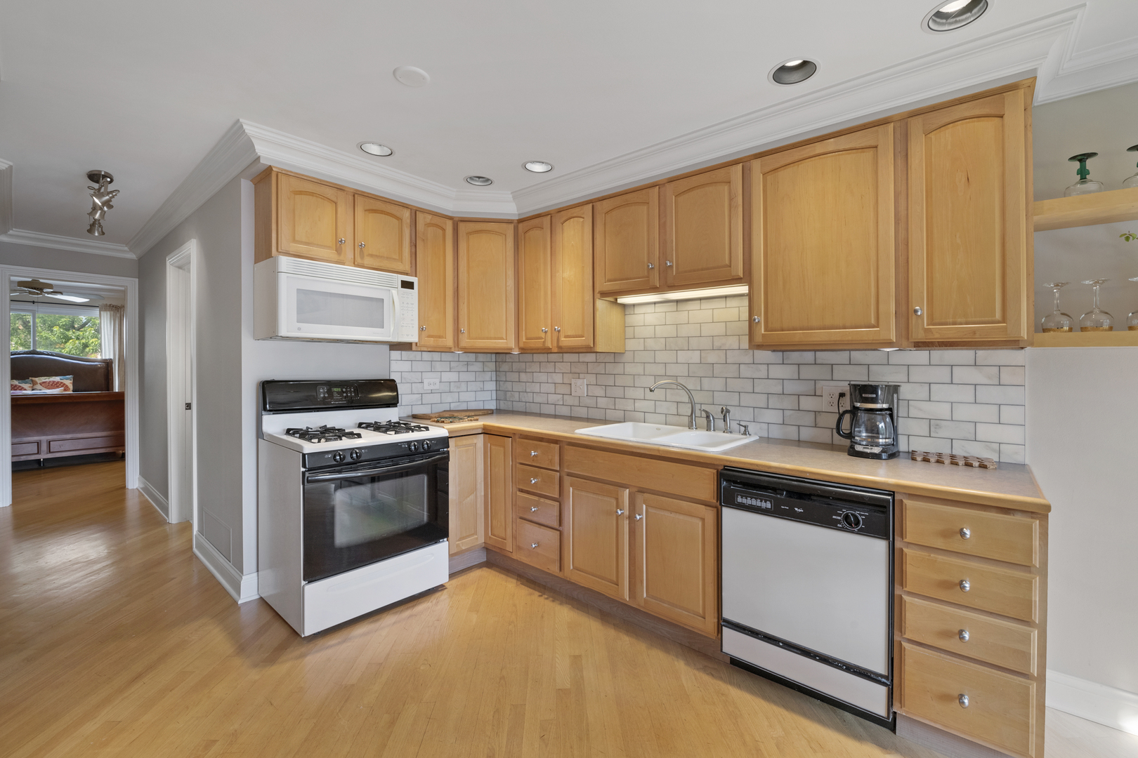 375 Juniper Tree Court Hoffman Estates, IL 60169 - Photo 7 of 24 a kitchen with stainless steel appliances granite countertop a sink stove and cabinets