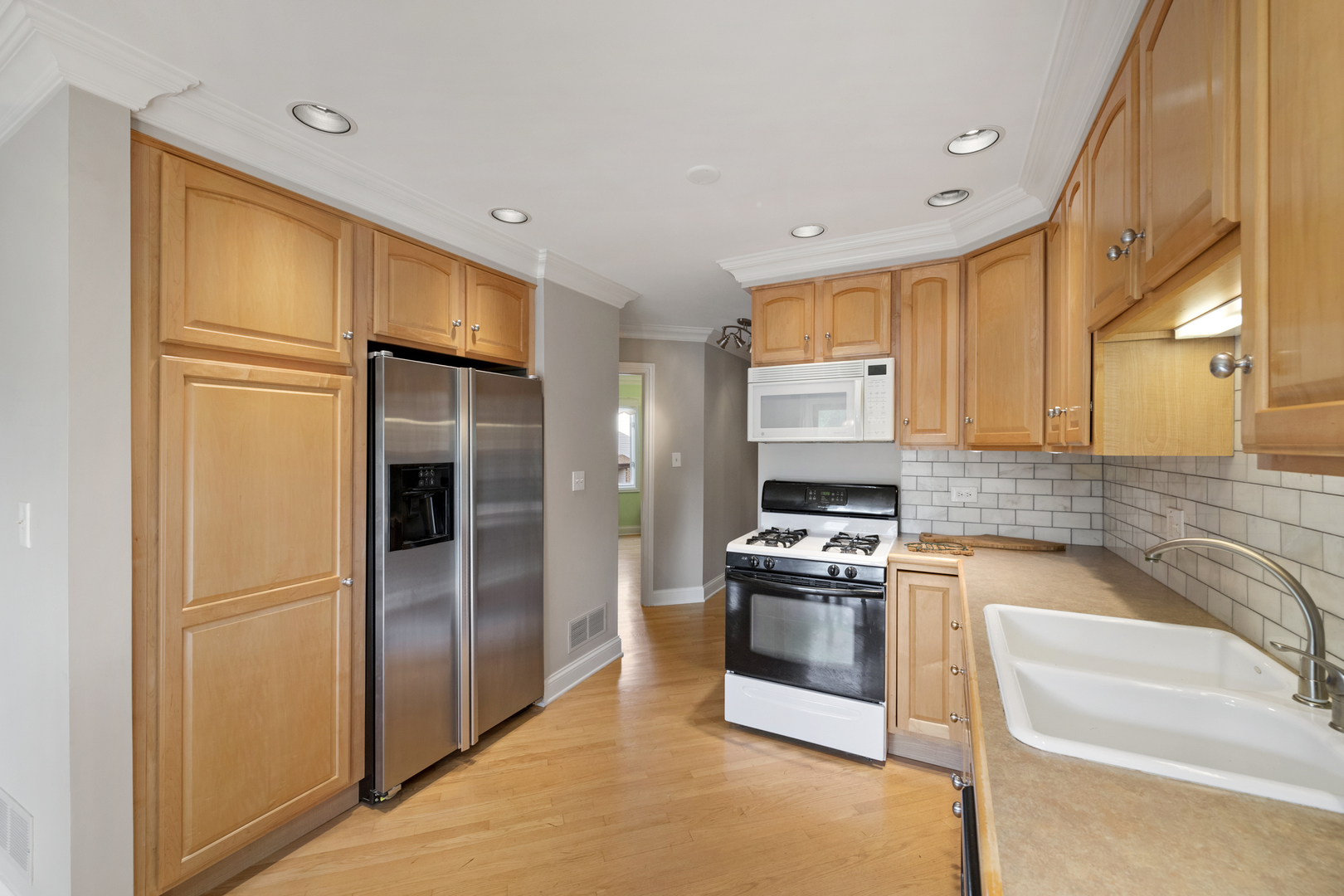 375 Juniper Tree Court Hoffman Estates, IL 60169 - Photo 8 of 24 a kitchen with granite countertop stainless steel appliances and a refrigerator