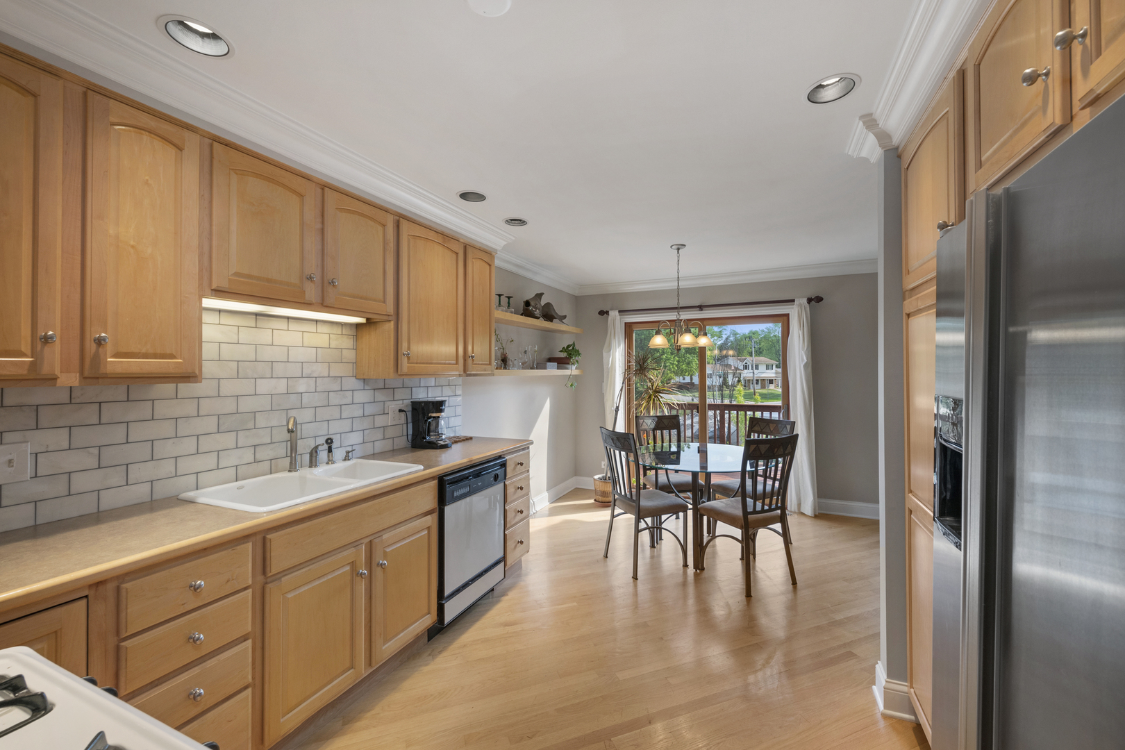375 Juniper Tree Court Hoffman Estates, IL 60169 - Photo 9 of 24 a kitchen with a table chairs refrigerator and cabinets