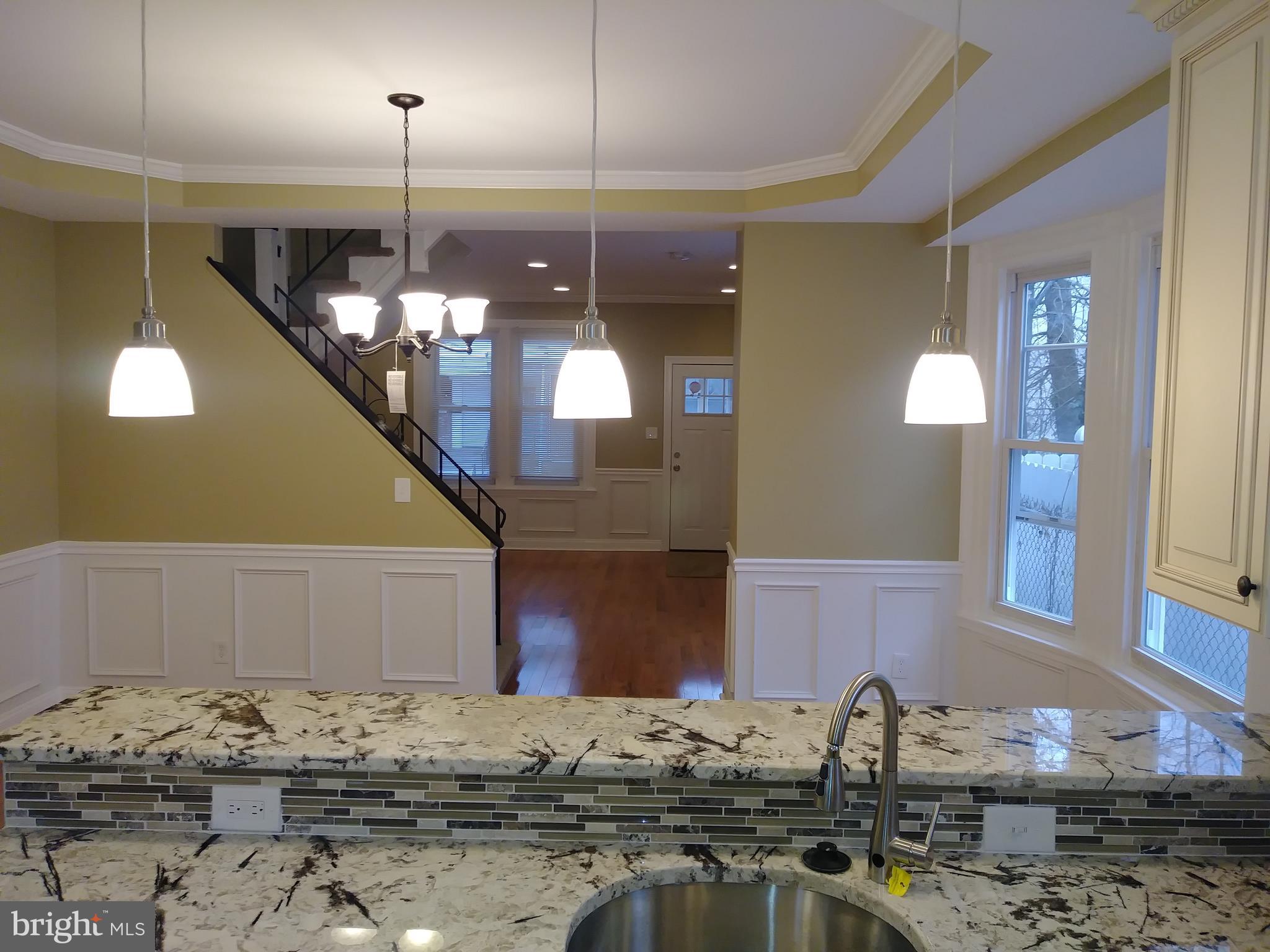 a kitchen with a sink and chandelier
