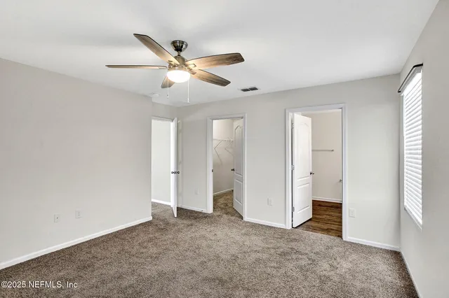 a view of a swimming pool and trees in the background