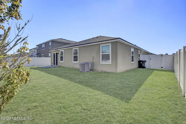 a kitchen with white cabinets sink and stainless steel appliances
