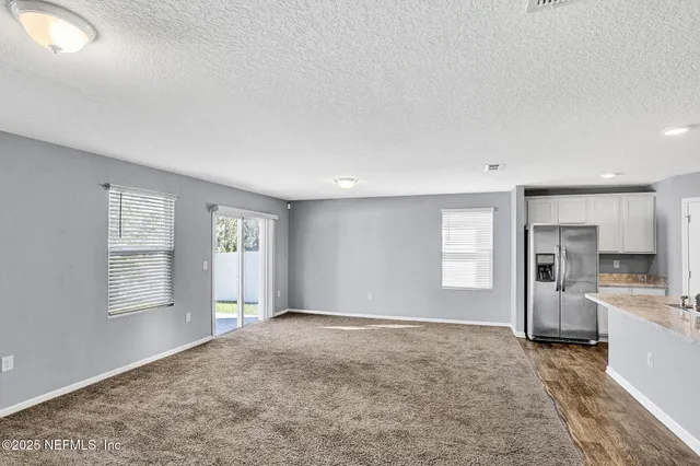 a view of a patio with table and chairs potted plants with wooden floor and fence