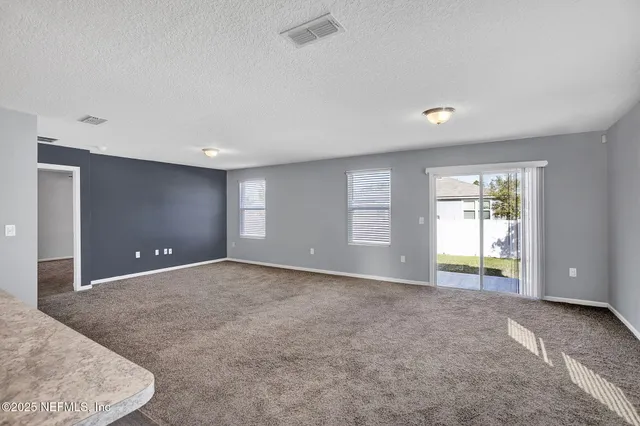 a view of a swimming pool with lawn chairs under an umbrella