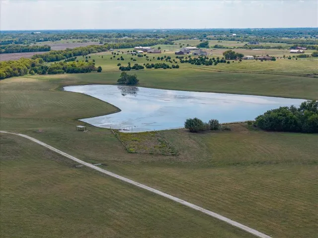 an aerial view of a houses with outdoor space and river