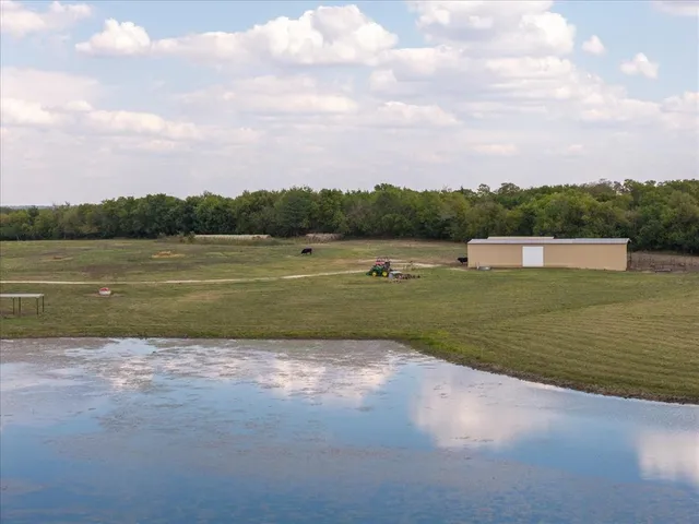 a view of a lake with houses in the back