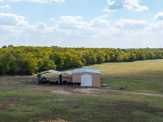 a aerial view of a house with garden space and trees