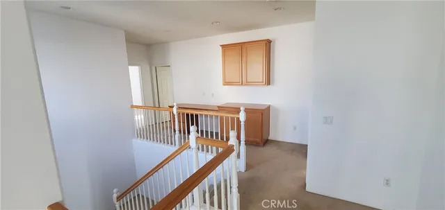 an empty room with windows and entrance