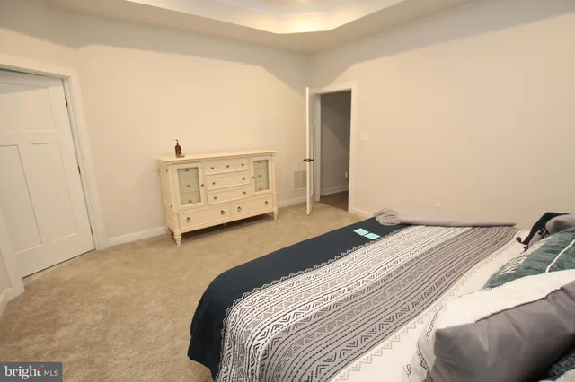 a bedroom with a bed and cabinets