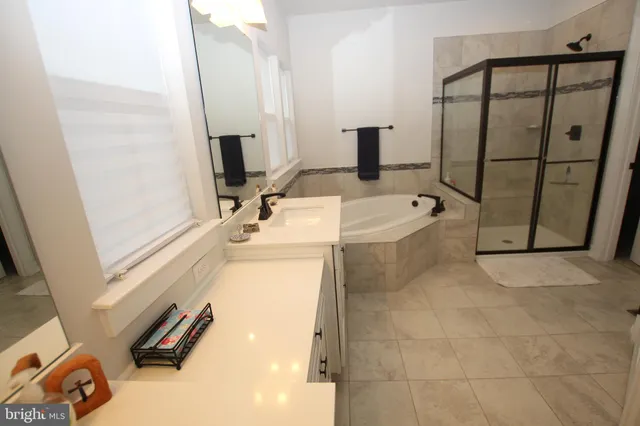 a bathroom with a tub sink and a mirror