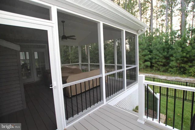 a balcony with wooden floor and furniture