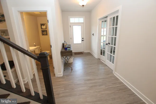 a view of an entryway with wooden floor