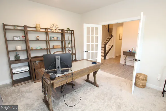 a work room with furniture and a floor to ceiling window