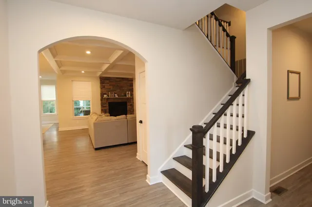 a view of entryway and hall with wooden floor