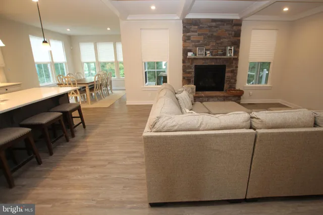 a living room with furniture wooden floor and a fireplace