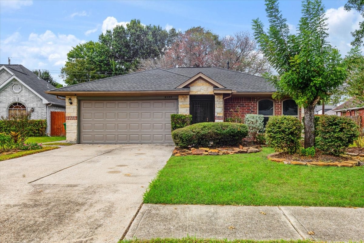 6123 Springhaven Drive Houston, TX 77396 - Photo 1 of 36 Welcome to 6123 Springhaven Drive! Classic brick and stone accents, established landscaping and a two-car garage create an inviting first impression.