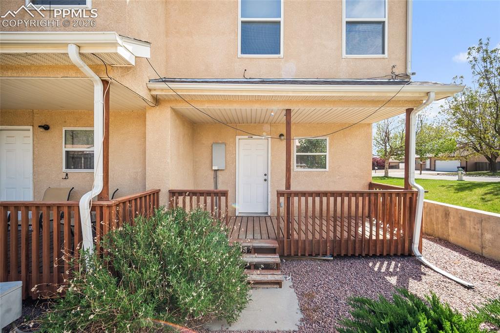4400 Rawhide Road, Unit 157 Pueblo, CO 81008 - Photo 31 of 36 a view of a house with a small yard and wooden floor and fence