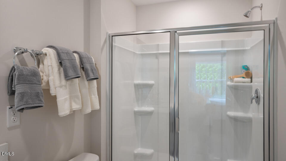 304 Perseus Street Angier, NC 27501 - Photo 26 of 34 a bathroom that has a glass shower door