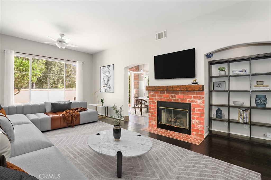 1175 Corte Riviera Camarillo, CA 93010 - Photo 3 of 23 a living room with furniture a fireplace and a flat screen tv
