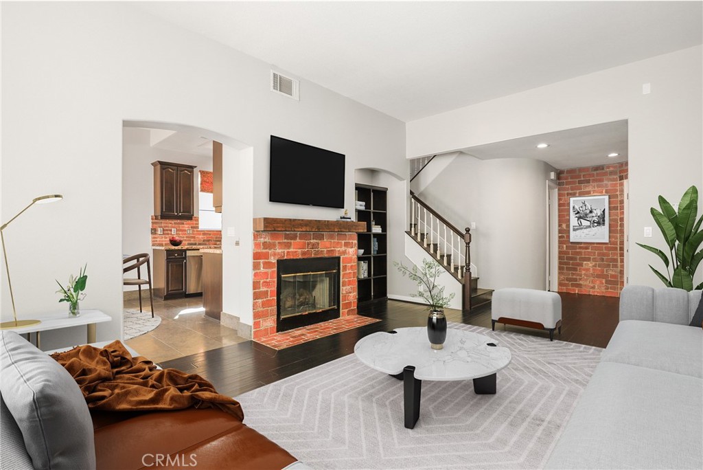 1175 Corte Riviera Camarillo, CA 93010 - Photo 4 of 23 a living room with furniture a fireplace and a flat screen tv