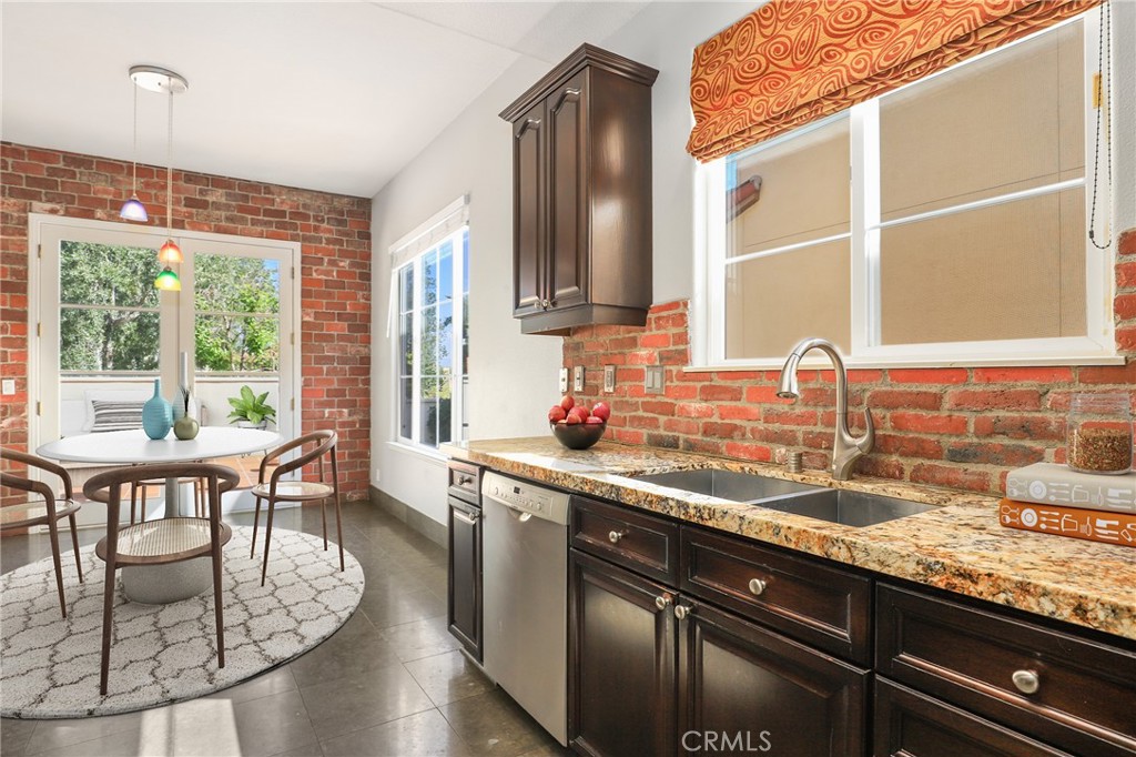 1175 Corte Riviera Camarillo, CA 93010 - Photo 6 of 23 a kitchen with stainless steel appliances granite countertop a sink and a wooden cabinets