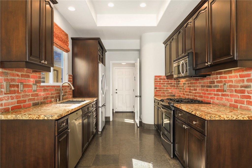 1175 Corte Riviera Camarillo, CA 93010 - Photo 7 of 23 a kitchen with stainless steel appliances granite countertop a sink stove and cabinets