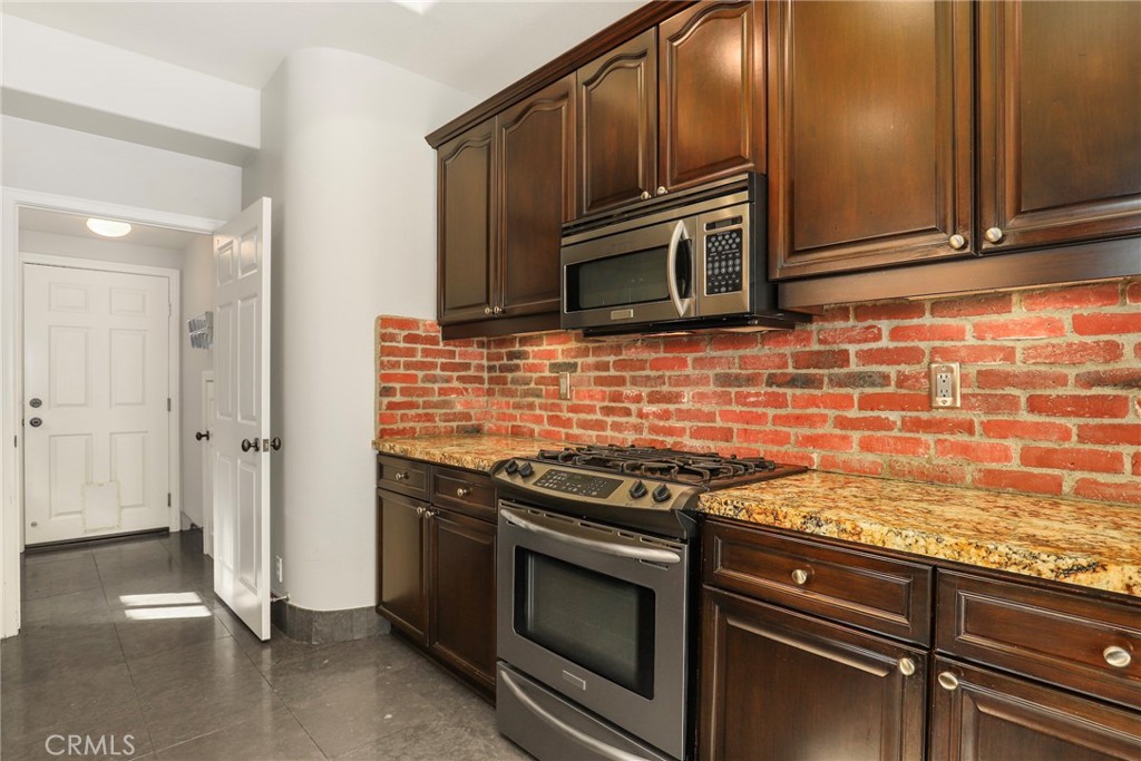 1175 Corte Riviera Camarillo, CA 93010 - Photo 8 of 23 a kitchen with granite countertop cabinets stainless steel appliances and wooden floor