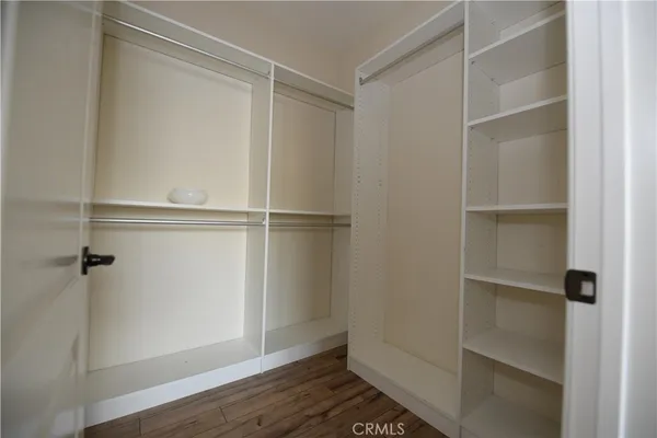 a view of walk in closet with empty racks