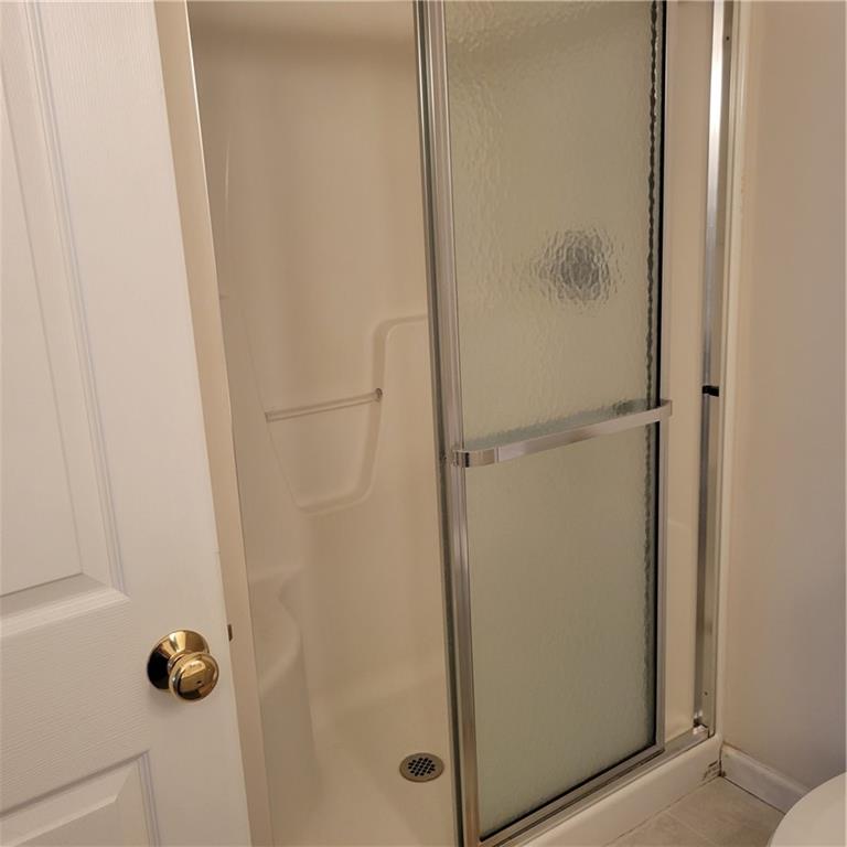 111 Wood Hawk Lane Butler, PA 16001 - Photo 11 of 13 a bathroom with a glass shower door