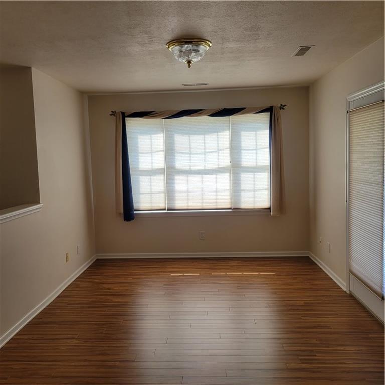 111 Wood Hawk Lane Butler, PA 16001 - Photo 5 of 13 a view of an empty room with wooden floor and a window