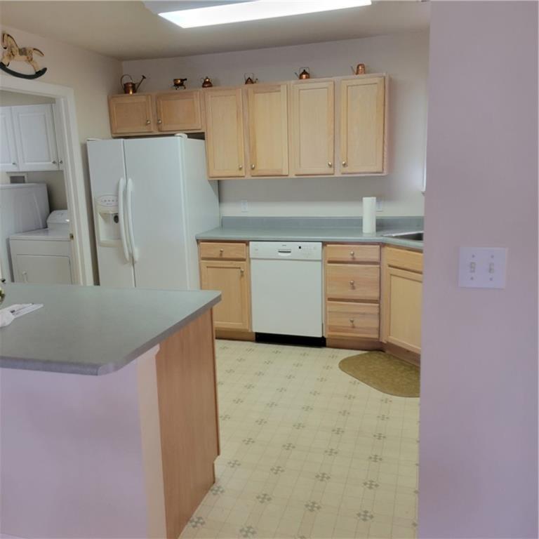 111 Wood Hawk Lane Butler, PA 16001 - Photo 7 of 13 a kitchen with granite countertop cabinets and white appliances