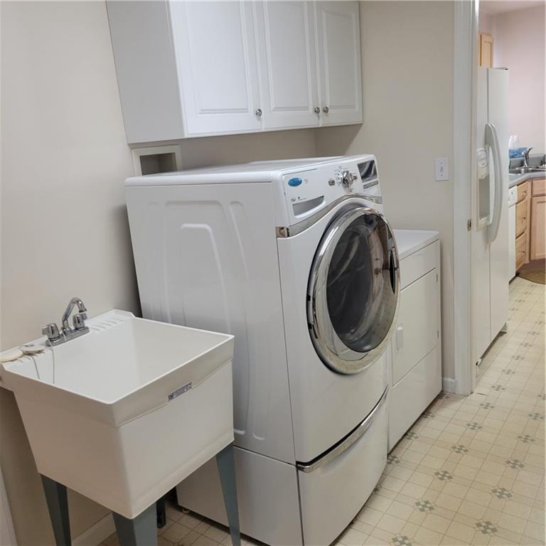 111 Wood Hawk Lane Butler, PA 16001 - Photo 8 of 13 a utility room with sink dryer and washer