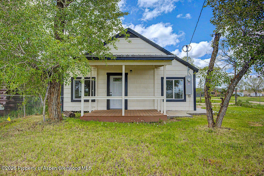 54 South Ranney Street Craig, CO 81625 - Photo 1 of 32 a view of a house with a yard and sitting area