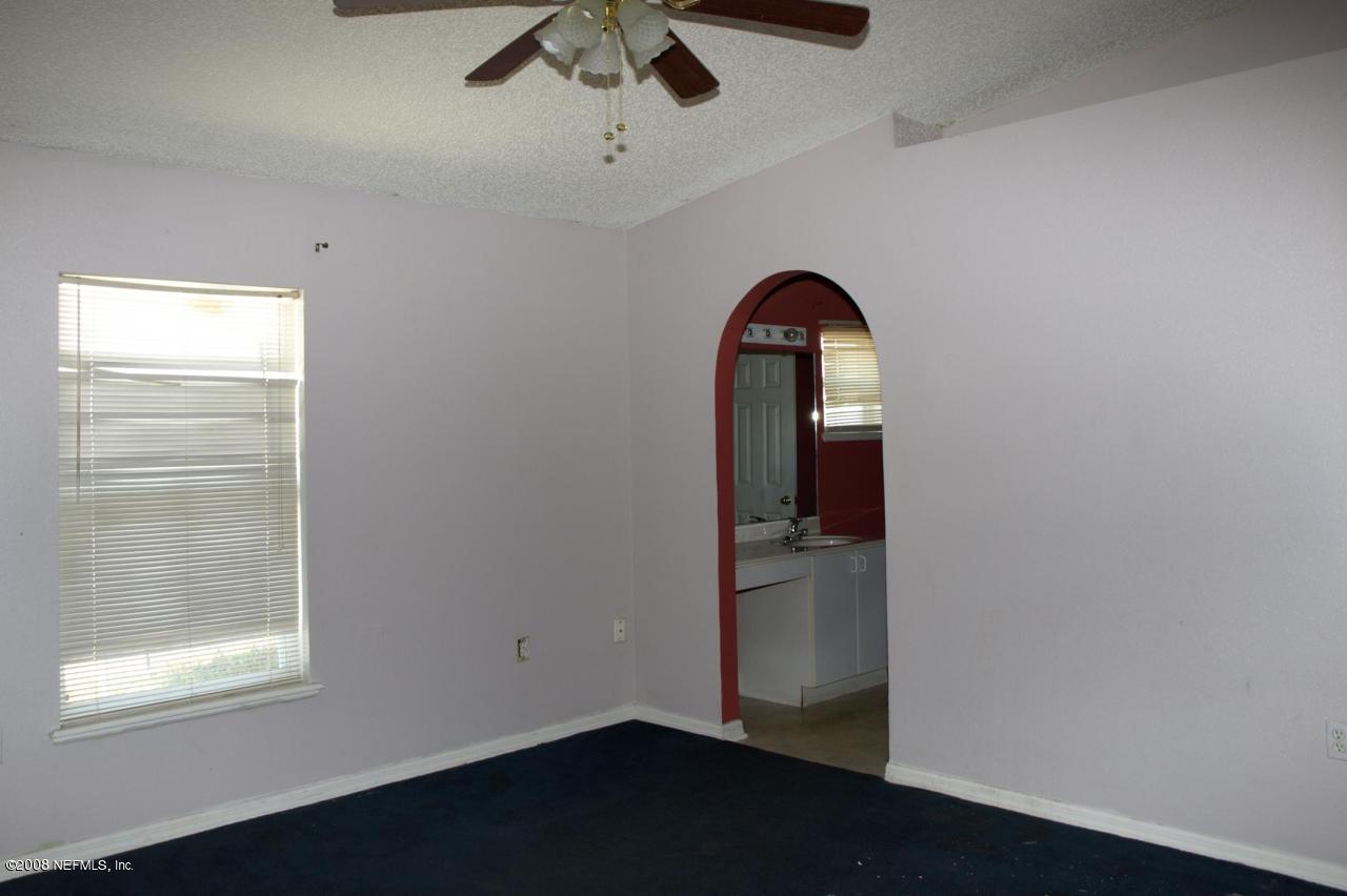 7387 Spring Hill Road Jacksonville, FL 32244 - Photo 9 of 15 a room with a window and a ceiling fan