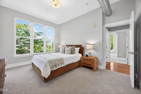 a spacious bedroom with a bed and window