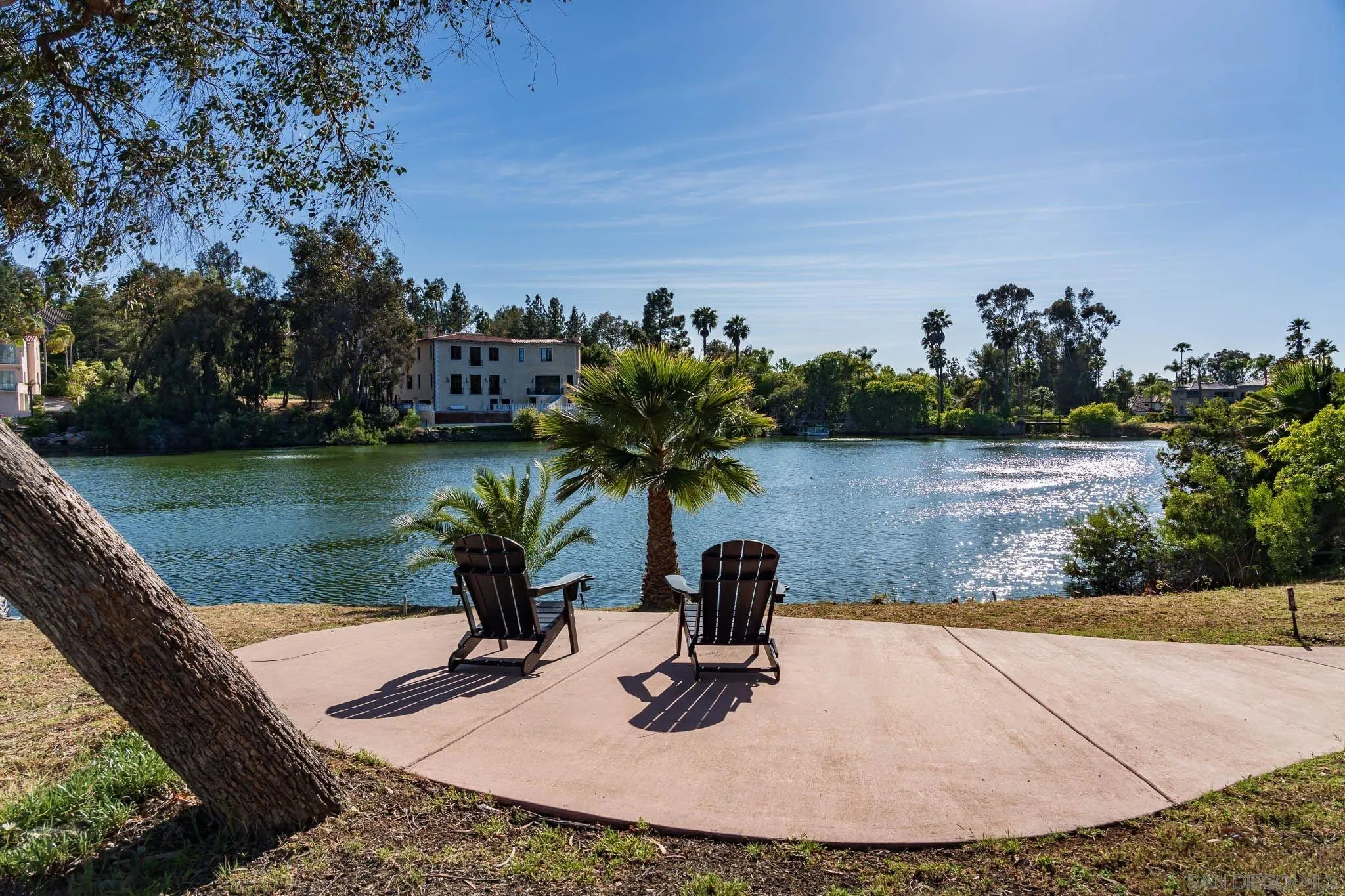 17249 Camino De Montecillo Rancho Santa Fe, CA 92067 - Photo 18 of 21 a view of a lake with a table and chairs in the patio