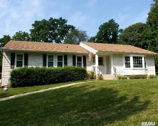 8 Fox Hollow Road Setauket, NY 11733 - Photo 1 of 1 a front view of a house with a garden
