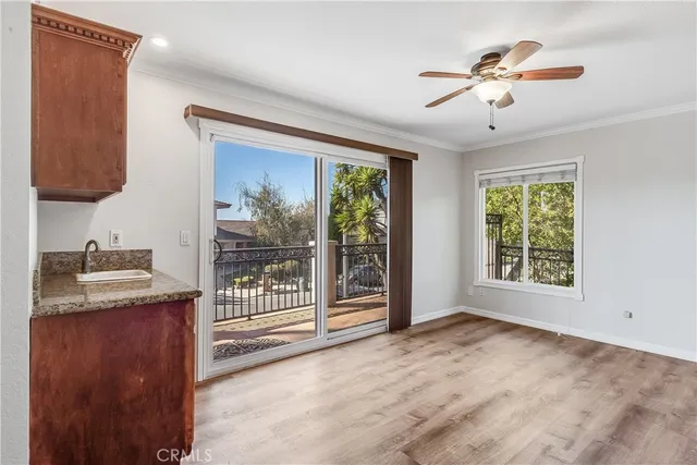 a view of a livingroom with a ceiling fan and window