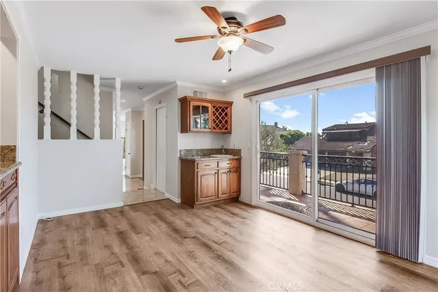 a view of a kitchen with furniture and a ceiling fan
