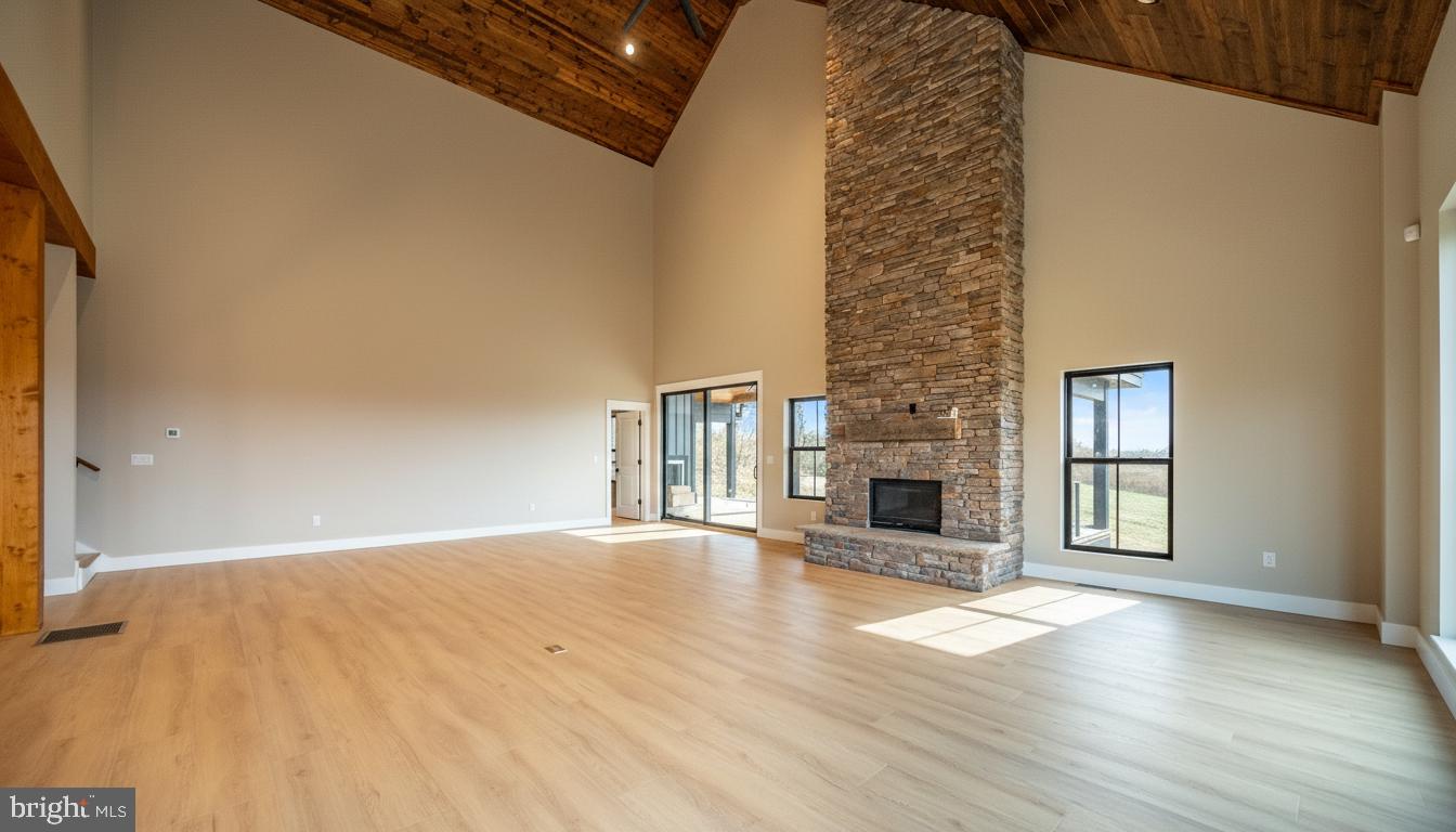 353 Lower Camp Road McHenry, MD 21541 - Photo 12 of 67 a view of a livingroom with wooden floor and a fireplace