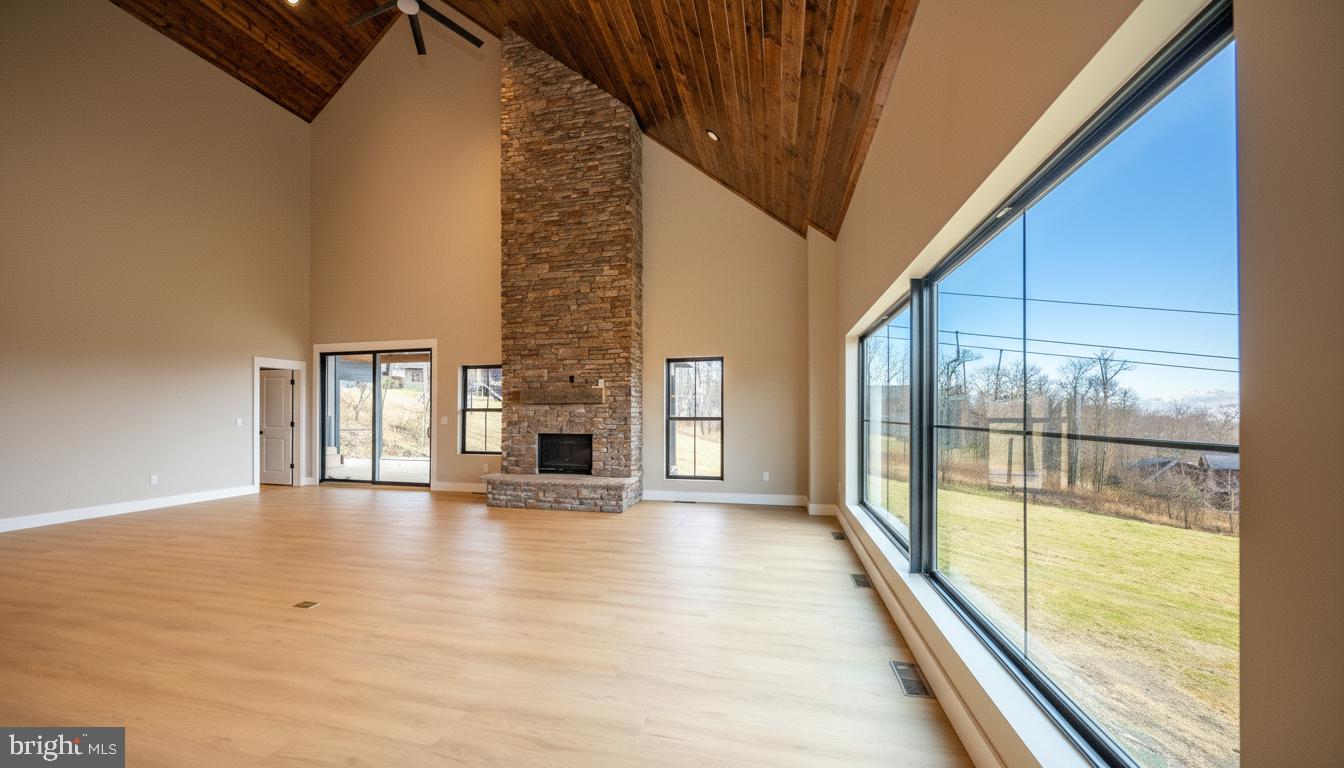 353 Lower Camp Road McHenry, MD 21541 - Photo 4 of 67 a view of an empty room with wooden floor and a window