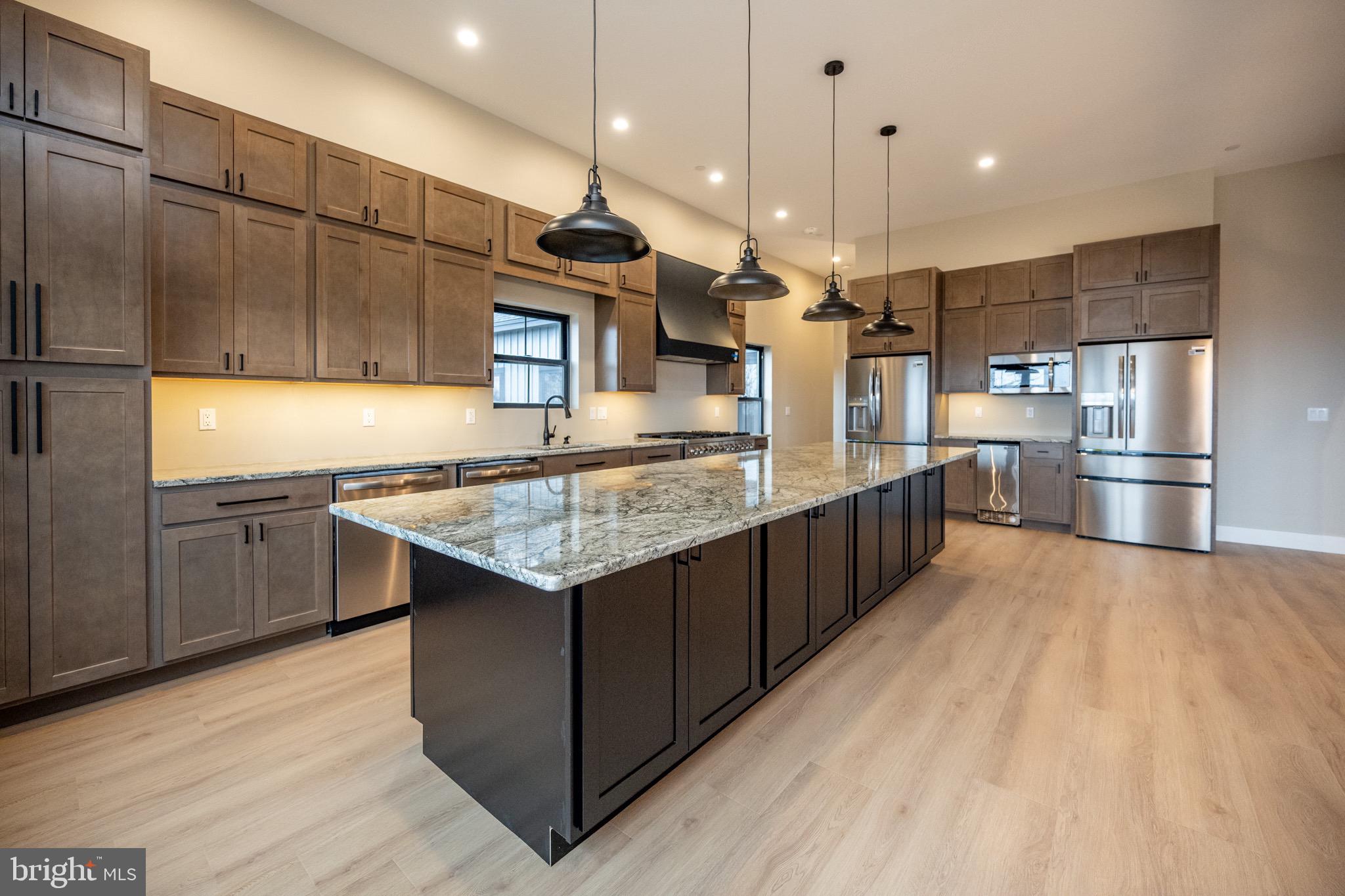 353 Lower Camp Road McHenry, MD 21541 - Photo 7 of 67 a kitchen with stainless steel appliances kitchen island granite countertop a table and chairs