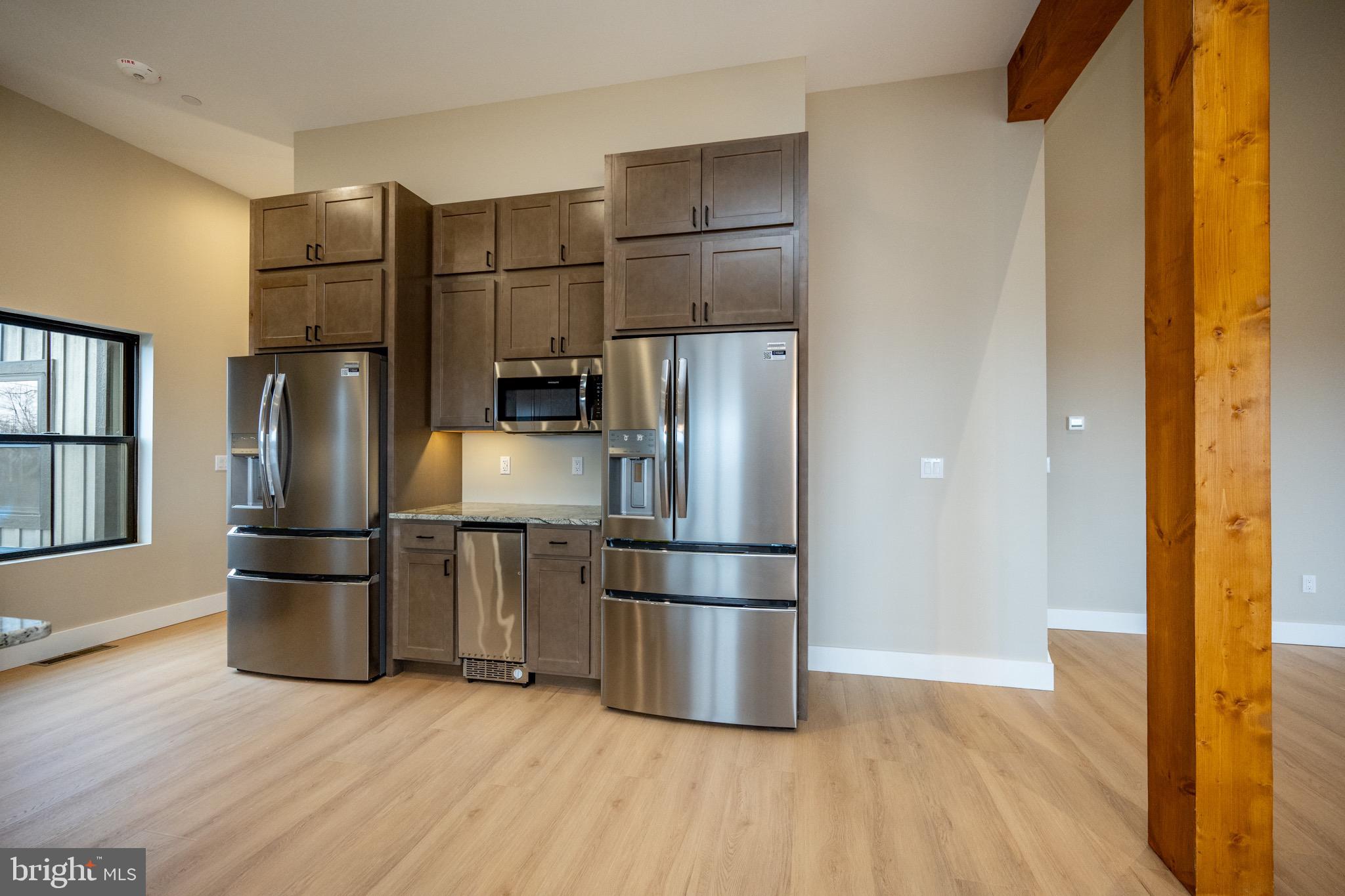353 Lower Camp Road McHenry, MD 21541 - Photo 8 of 67 a kitchen with stainless steel appliances a refrigerator and wooden floor